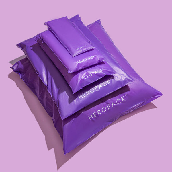 Purple compostable HEROPACK mailers in 5 sizes stacked- xs, s, m, l, xl